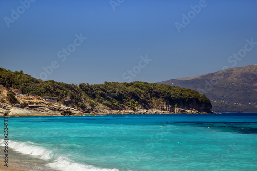 Fototapeta Naklejka Na Ścianę i Meble -  Beautiful beach with umbrellas for a holiday in Albania. Ionian Sea