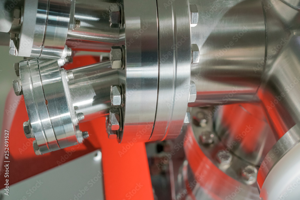Detail of vacuum equipment with steel flanges bolted to the vessel in laboratory or industrial environment. Abstract industrial or technology background. Detail of vacuum equipment with steel flanges bolted to the vessel in laboratory or industrial environment. Abstract industrial or technology background.