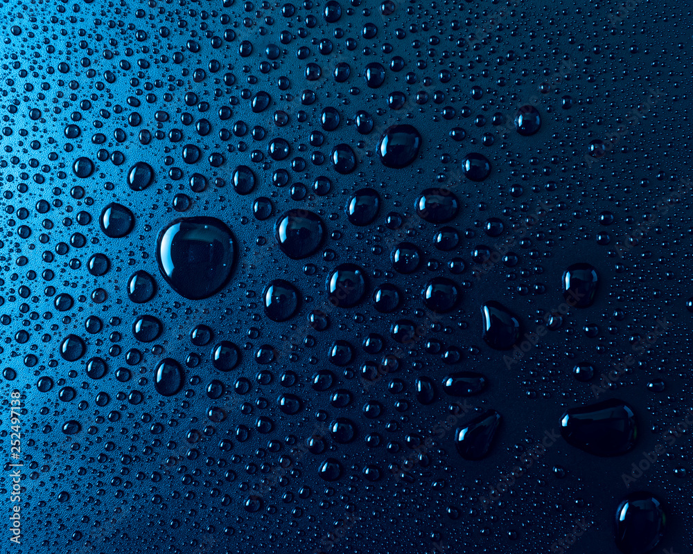 Drops of water on a blue glass texture background