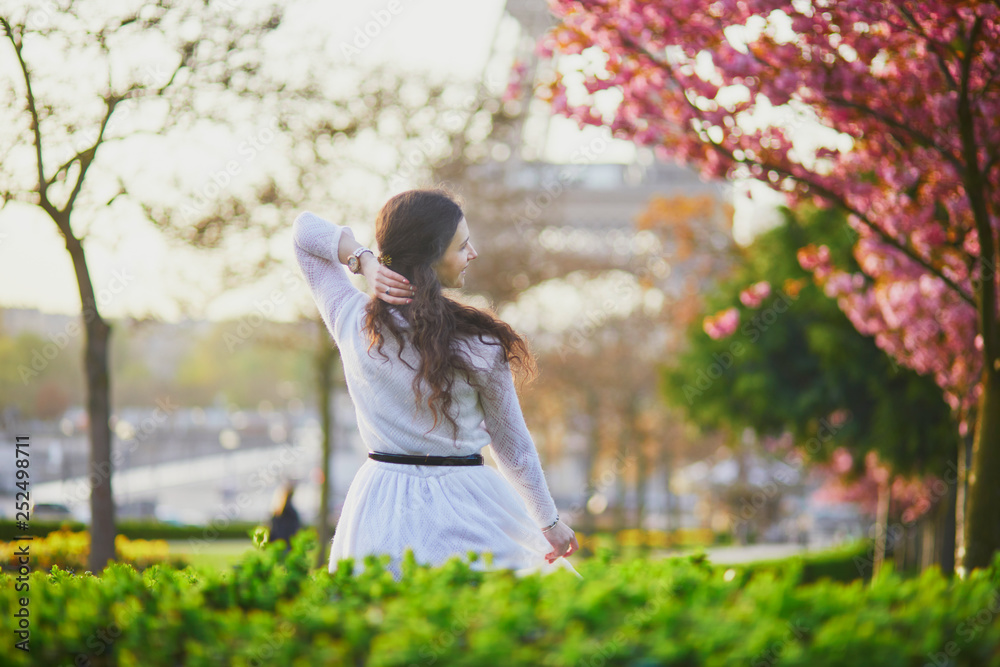 Naklejka premium Woman enjoying cherry blossom season in Paris, France