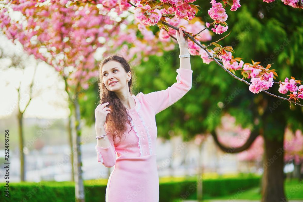 Woman enjoying cherry blossom season in Paris, France Woman enjoying cherry blossom season in Paris, France