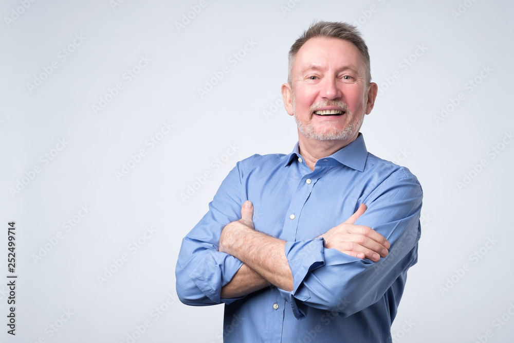 Confident handsome mature man in casual suit looking at camera and smiling Confident handsome mature man in casual suit looking at camera and smiling