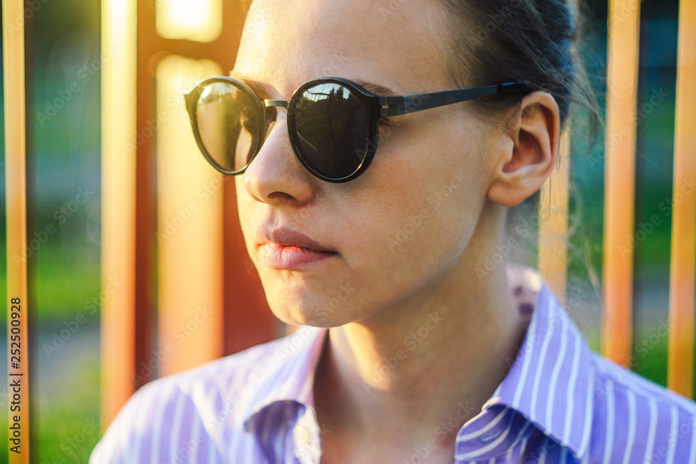 Portrait of a Young Woman in Sunglasses at Sunset.