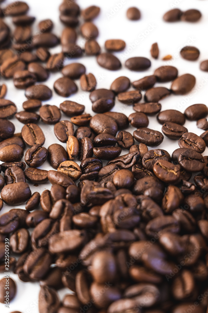 Pile of coffee beans close-up isolated on white background Pile of coffee beans close-up isolated on white background