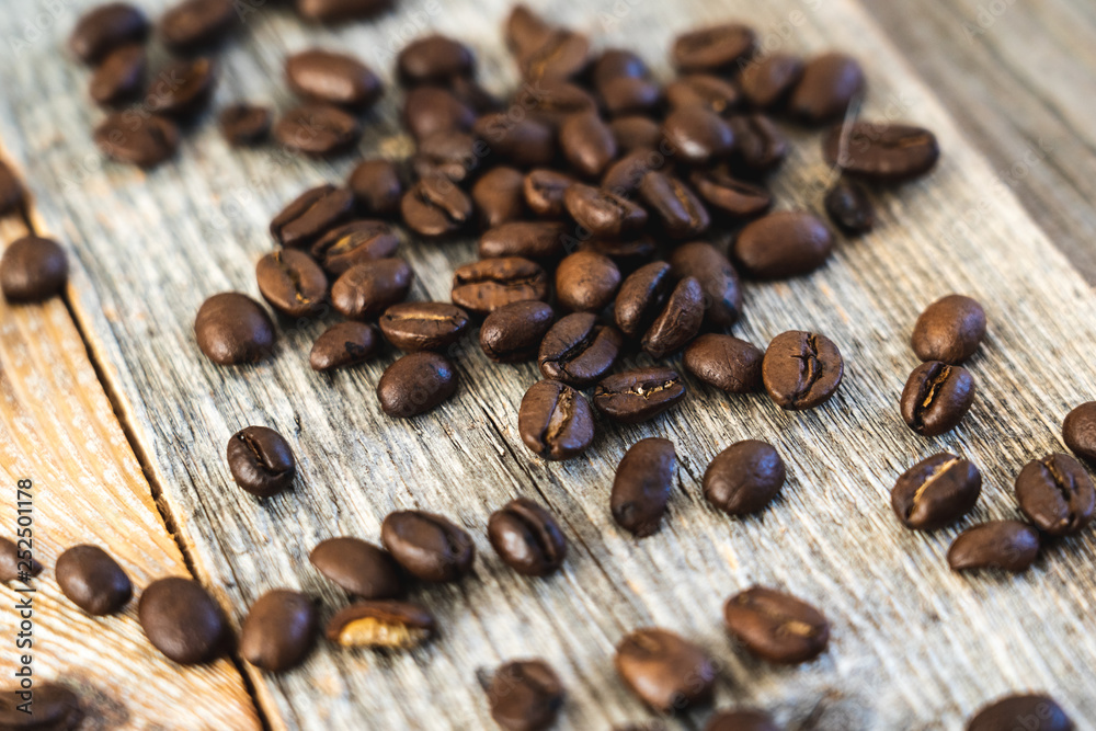 Roasted coffee beans on rustic wooden boards Roasted coffee beans on rustic wooden boards