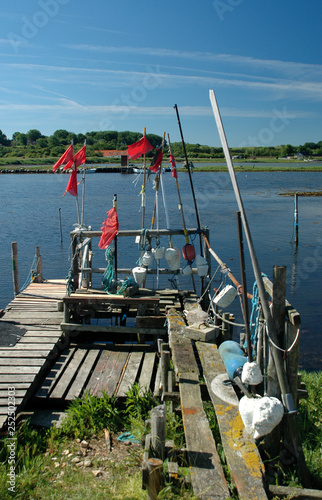 Small fishing hamlet with boats, and all kinds of fishing gear on a summer's day.