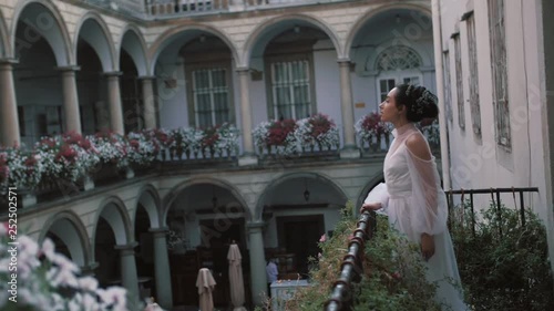 bride with a bouquet of flowers on the balcony