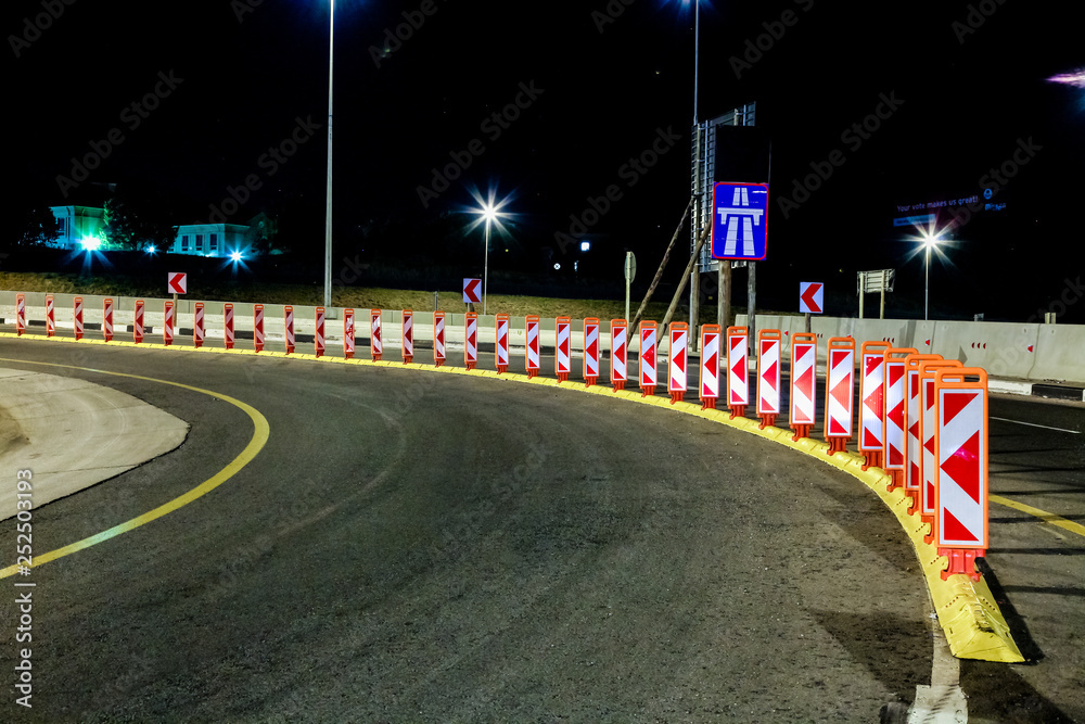 Fototapeta premium Motorway Signs and reflectors on Highway at night