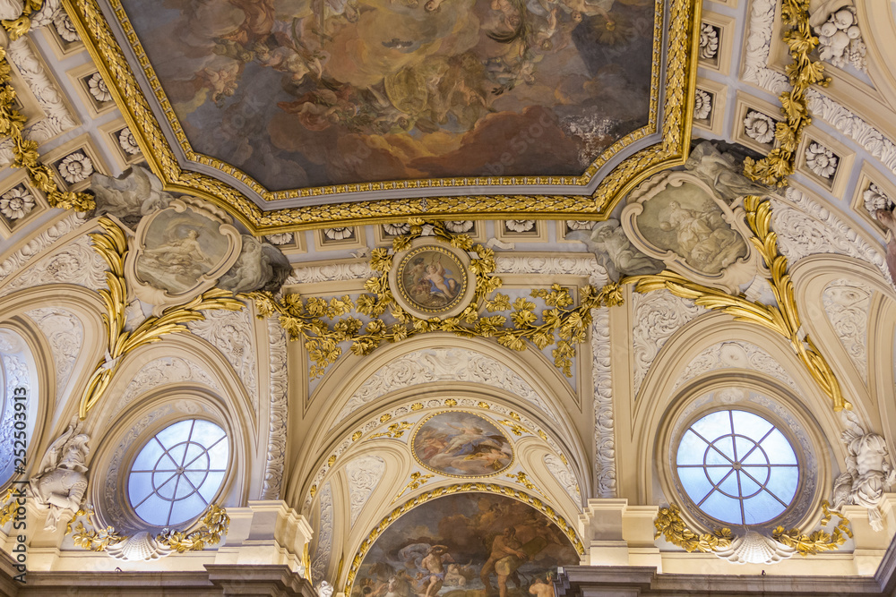 Stunningly beautiful ceiling with giant painting and gold decorative trim and classic roman style architecture