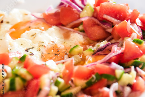 Fresh fried eggs served with salad.