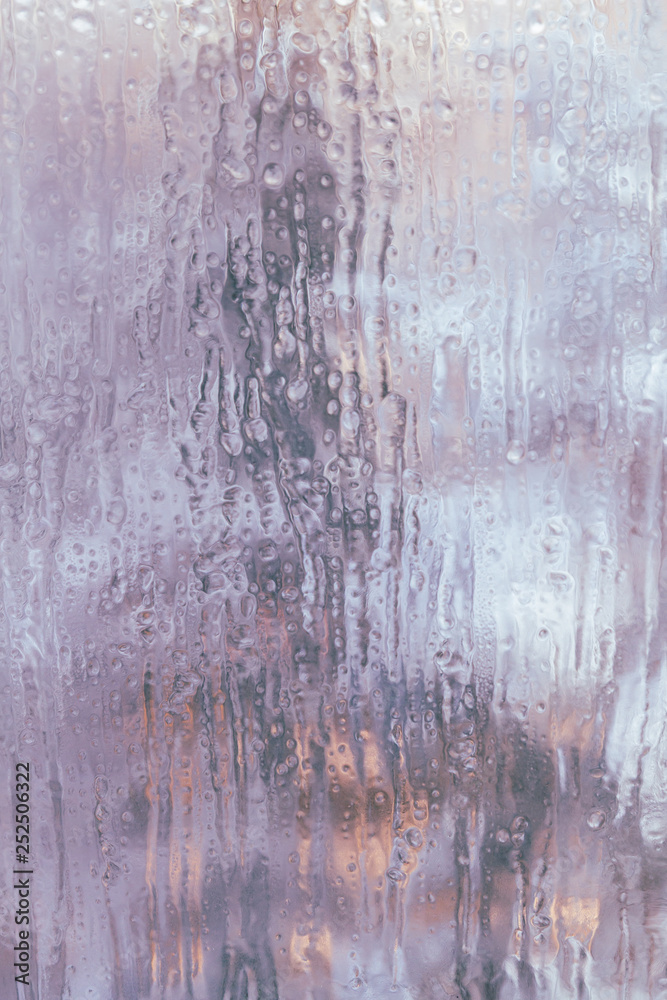 Frozen window in winter with drops and drips Frozen window in winter with drops and drips