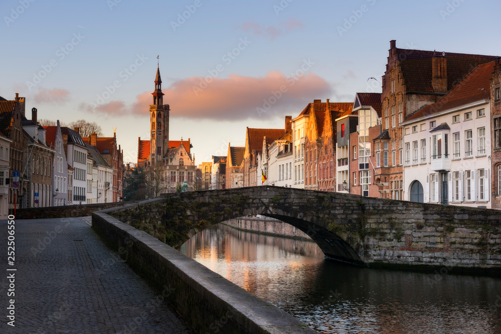 Naklejka premium Brugge evening cityscape. Old buildings at water channel in Bruges, Belgium
