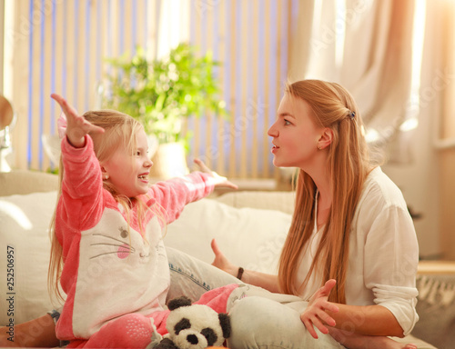 Fotografie Young mother and daughter are having fun playing at home, happy parenting and fa