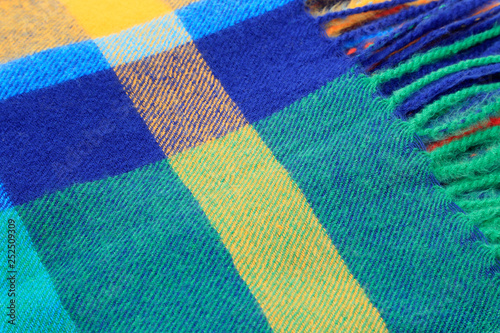 Texture of a bright multicolor scarf with fringe © Dinadesign