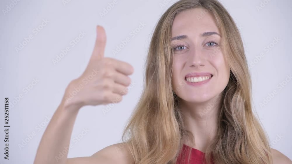Face of happy young beautiful blonde woman giving thumbs up Face of happy young beautiful blonde woman giving thumbs up