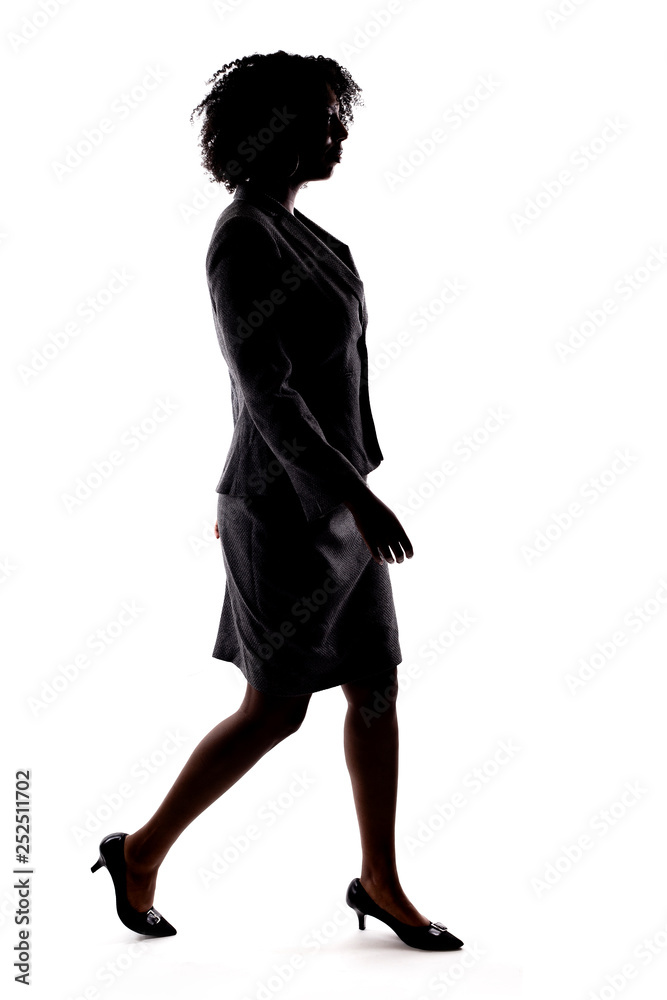Silhouette of a Black Businesswoman walking in side view isolated on a ...