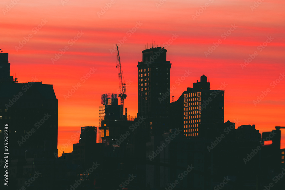 Silhouettes of buildings against colorful sky