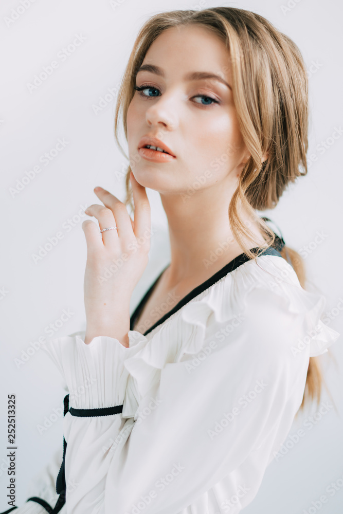 beautiful tender young girl, with flowers, dressed in a light dress, in a studio with natural light. posing, smiling, piercing gaze beautiful tender young girl, with flowers, dressed in a light dress, in a studio with natural light. posing, smiling, piercing gaze