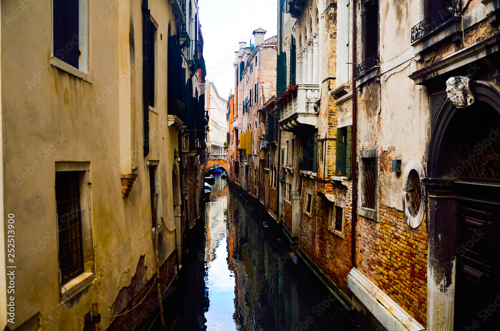 Romantic view of small canal water alleys in old city of Venice for school summer holiday