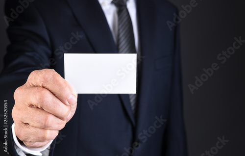 Close up of a businessman holding a blank white business card