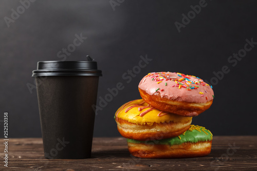 Wallpaper Mural Colorful donuts and coffee in a black paper Cup on a black background. Bakery menu design concept. Hanukkah background. Torontodigital.ca