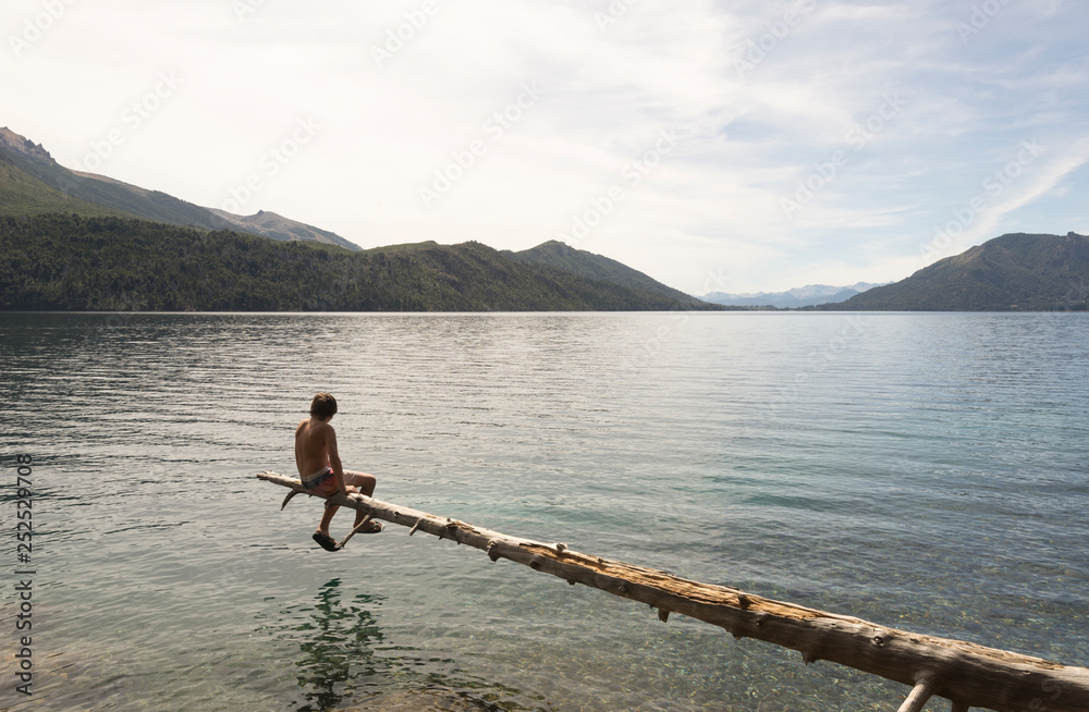 Meditating sitting on a tree above the lake. Meditating sitting on a tree above the lake.