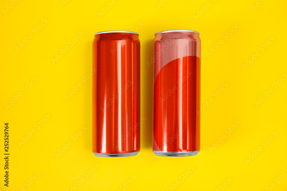 Blank metal red cans on color background, flat lay. Mock up for design Blank metal red cans on color background, flat lay. Mock up for design