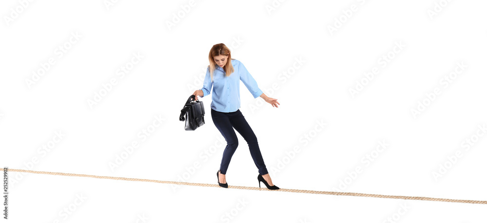 Φωτογραφία Full length portrait of businesswoman with briefcase balancing on rope against w