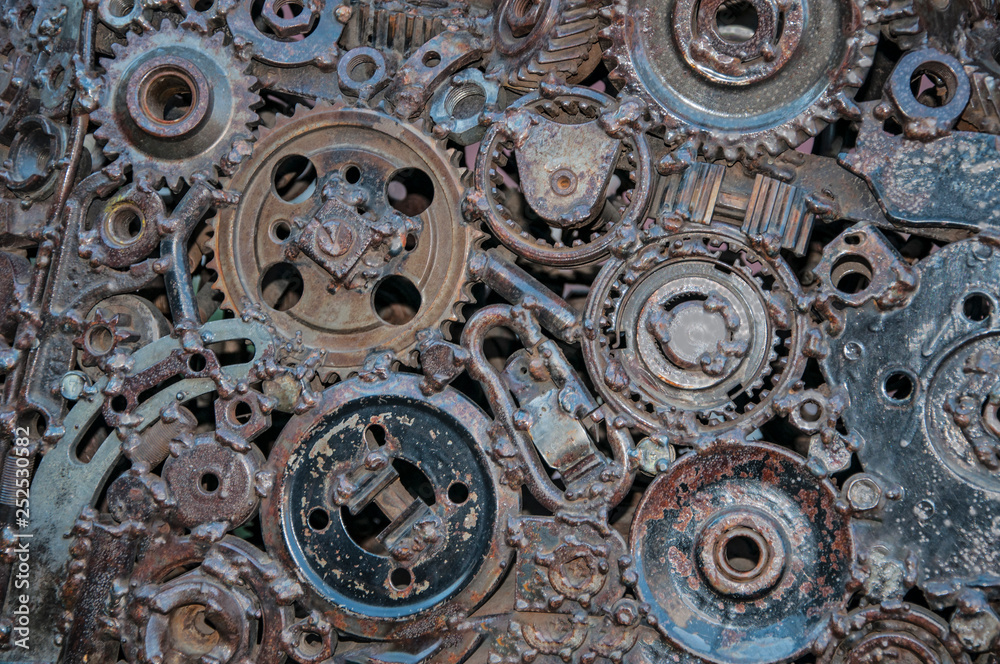 Old, worn, rough mechanical gears made of rusty metal. Design minimalism. Iron composition. Retro style. Stylish top and trendy design background round gears.