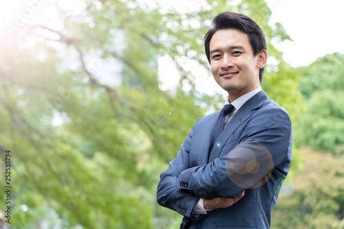 portrait of asian businessman in park