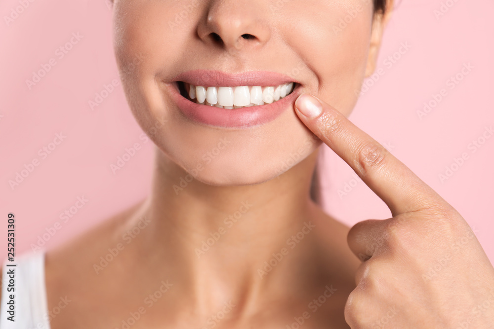 Young woman with healthy teeth on color background, closeup Young woman with healthy teeth on color background, closeup