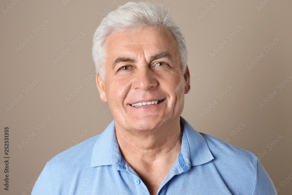 Mature man with healthy teeth on color background Mature man with healthy teeth on color background