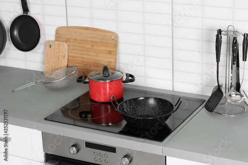 Clean cookware and utensils in modern kitchen