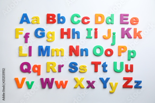 Plastic magnetic letters isolated on white, top view. Alphabetical order