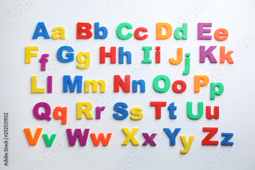 Plastic magnetic letters isolated on white  top view. Alphabetical order