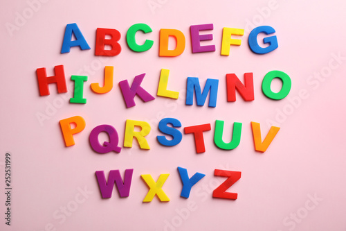 Plastic magnetic letters on color background, top view. Alphabetical order