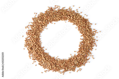 Frame made of uncooked buckwheat on white background, top view