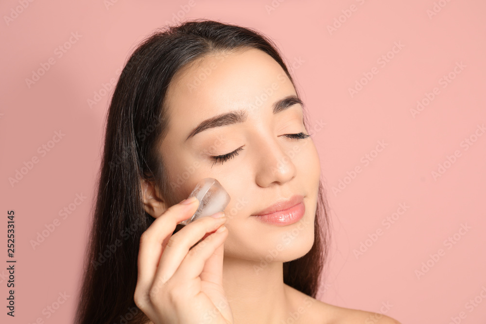 Young woman with ice cube on color background. Skin care Young woman with ice cube on color background. Skin care