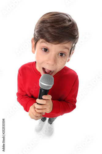 Obraz na plátne Cute little boy singing into microphone on white background