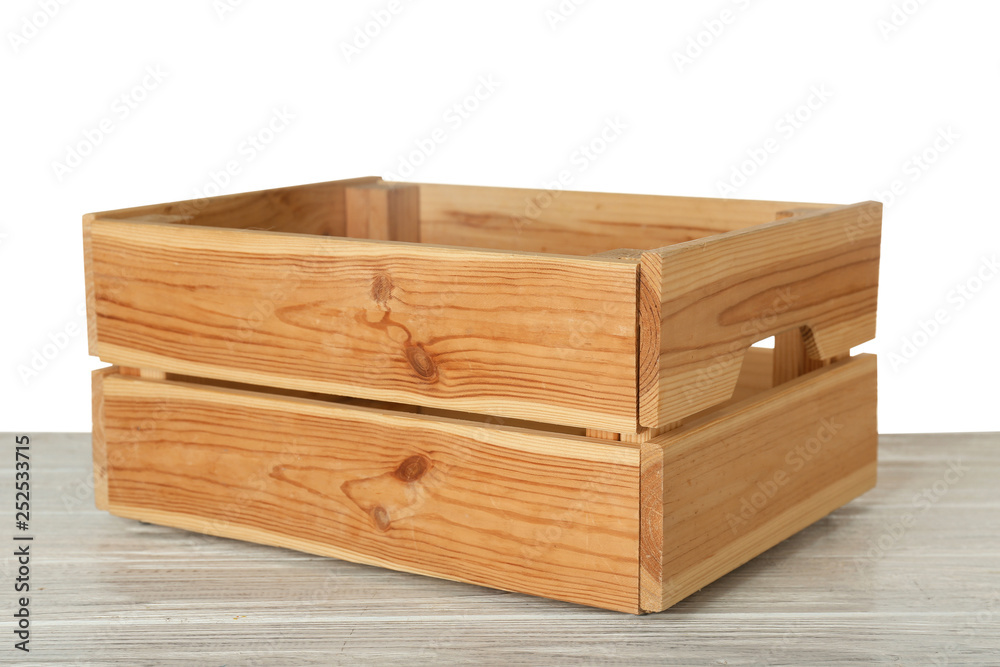 Empty rustic wooden crate on table against white background Empty rustic wooden crate on table against white background