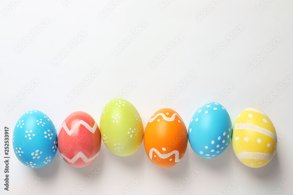 Beautiful painted Easter eggs on white background, top view