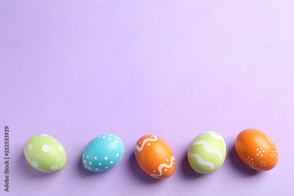 Beautiful painted Easter eggs on color background, flat lay. Space for text Beautiful painted Easter eggs on color background, flat lay. Space for text