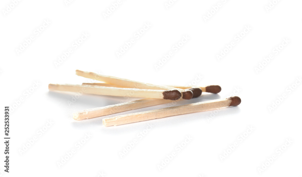 Several whole wooden matches on white background