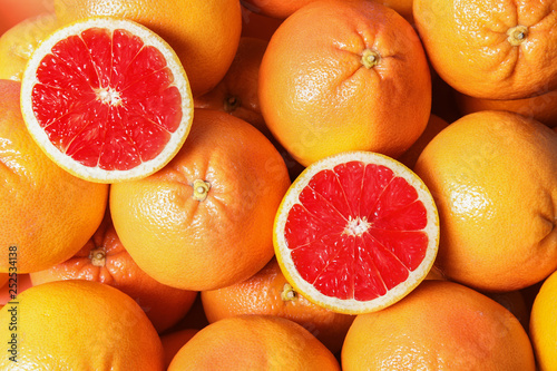 Many whole fresh ripe grapefruits as background, top view