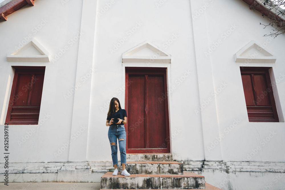 tourist woman a photographer stand in temple in traveler in vacation in Thailand nan province