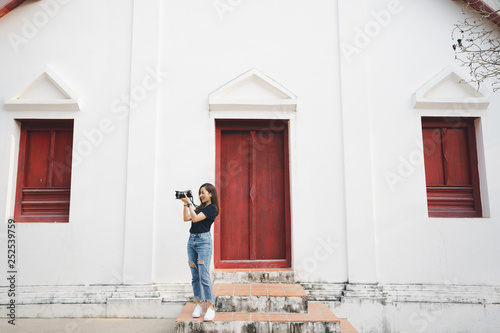 tourist woman a photographer stand in temple in traveler in vacation in Thailand nan province photo