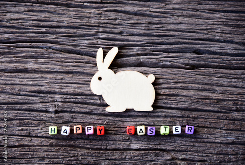 easter text and Wooden rabbit