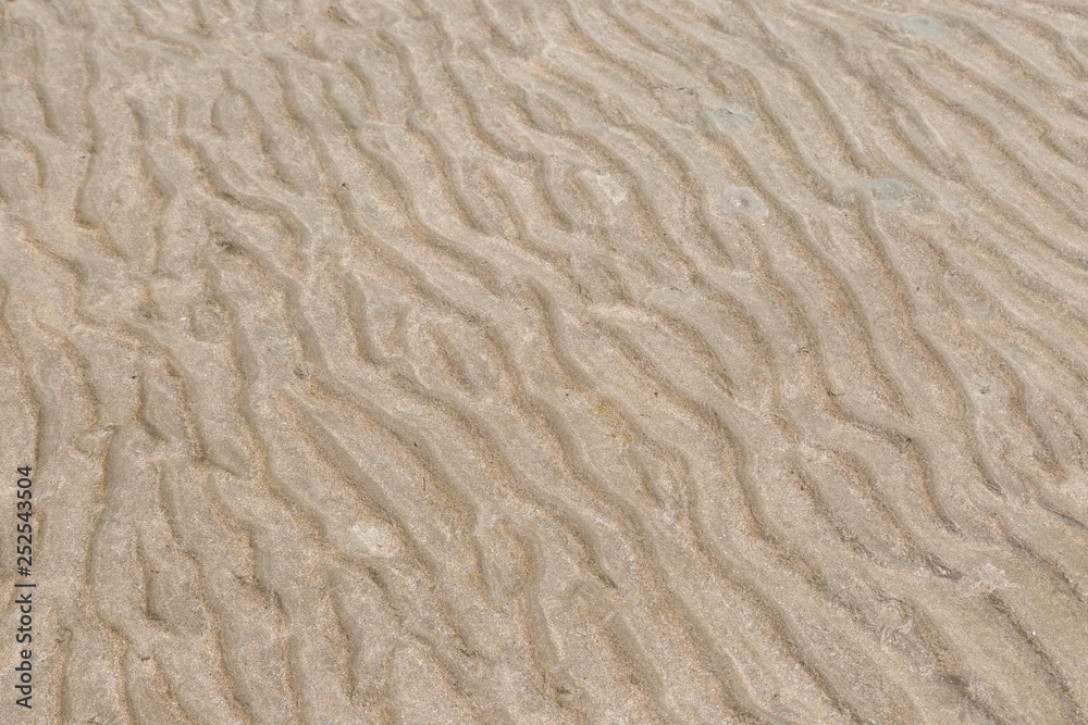 Yellow wave sand texture on the beach Yellow wave sand texture on the beach