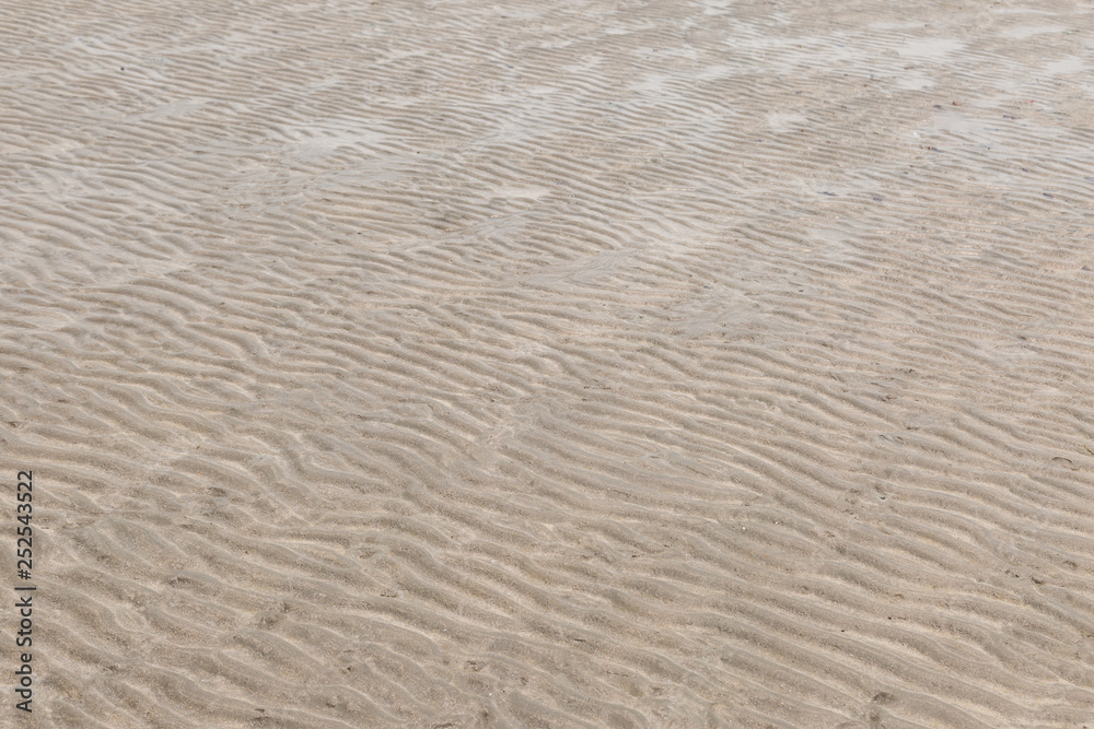 Yellow wave sand texture on the beach Yellow wave sand texture on the beach