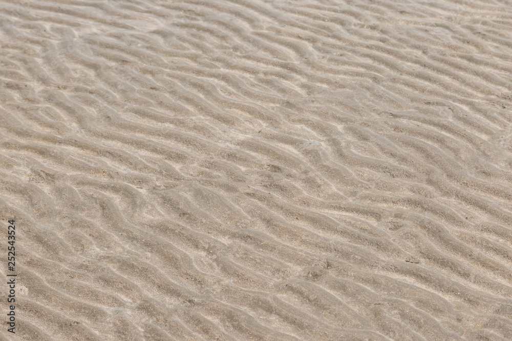 Fototapeta premium Yellow wave sand texture on the beach